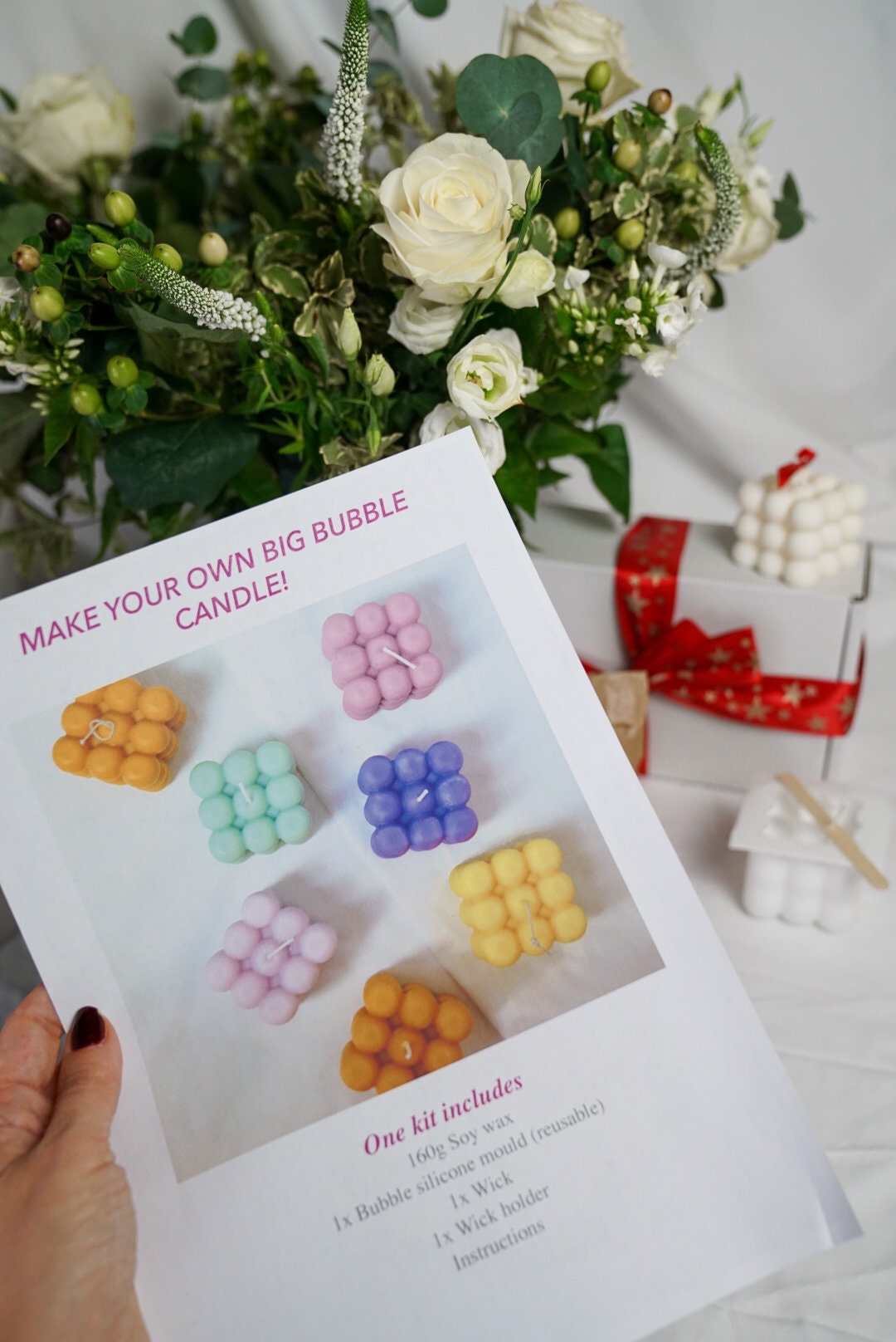 Make your own big Bubble Candle Making Kit with some bubble candles around and flowers on the background.