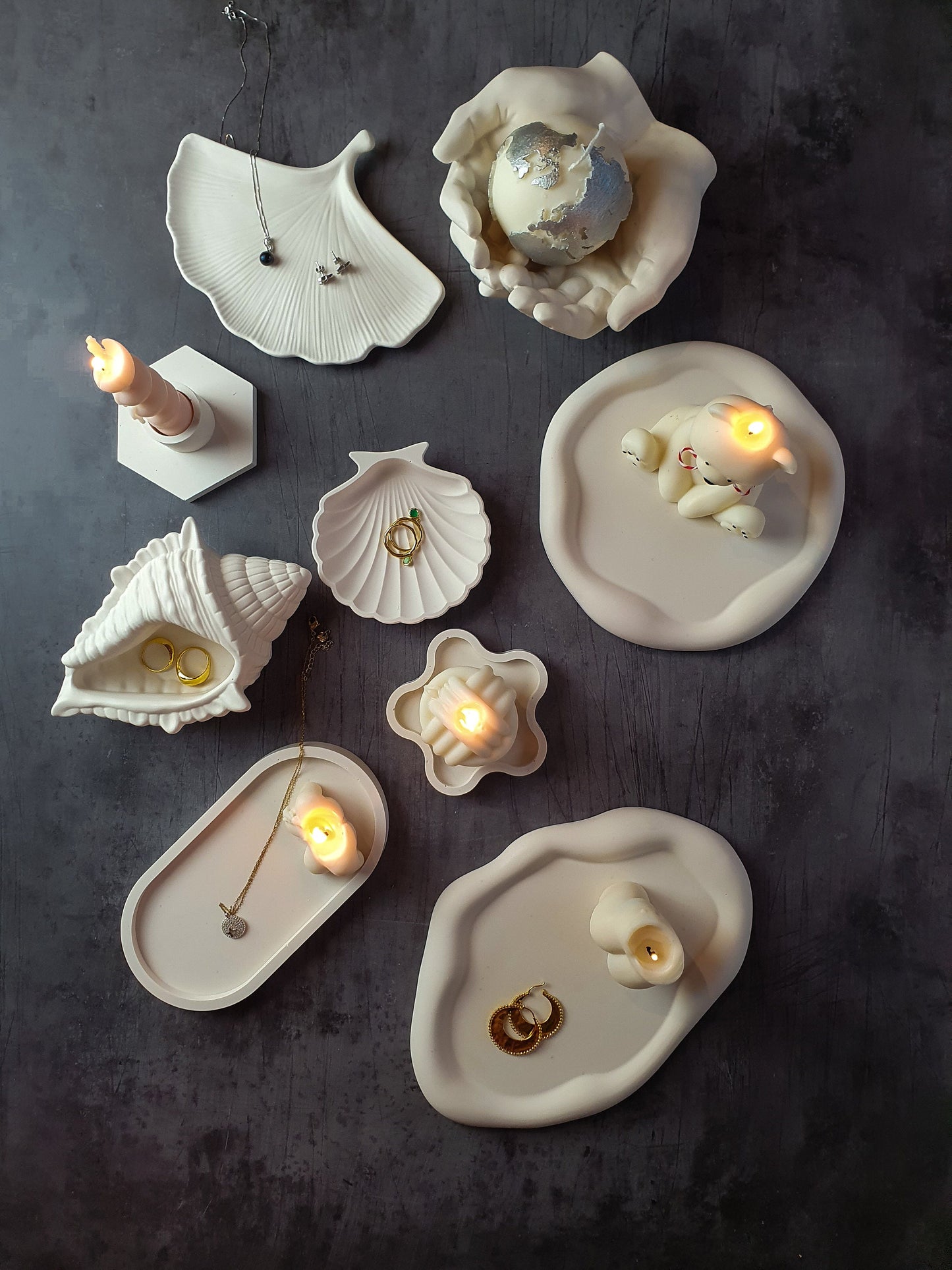 candles are sitting on a trinket trays.
