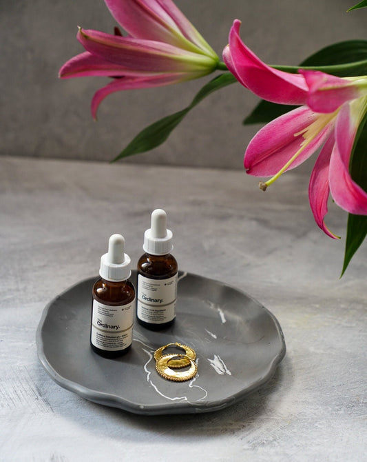 Large Round Jewellery Dish with some earrings in it.