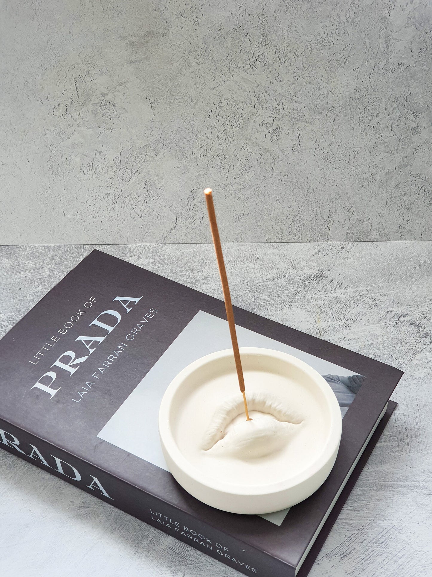 Lip Incense Holder with incense stick on it.