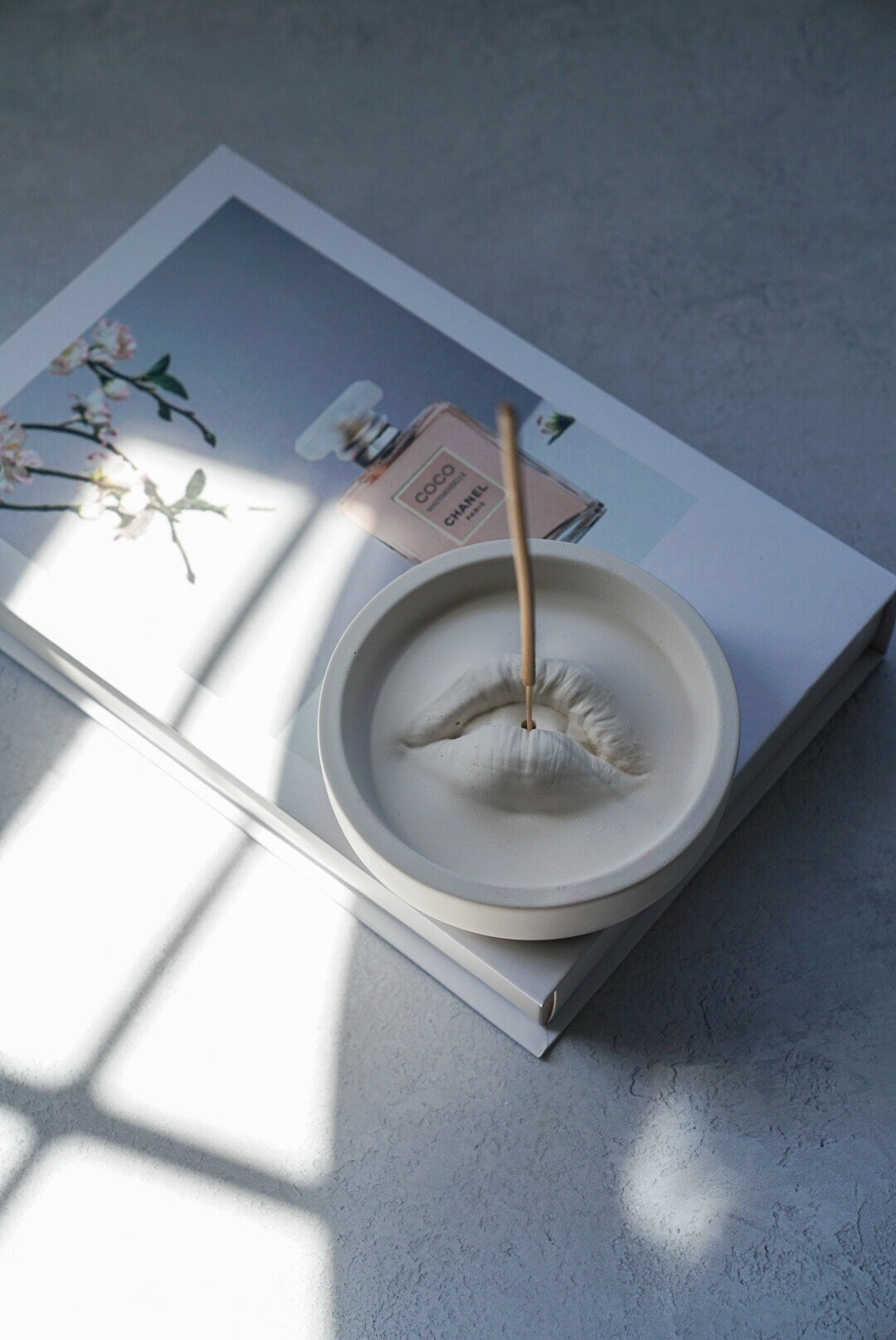 Lip Incense Holder with incense stick on it.
