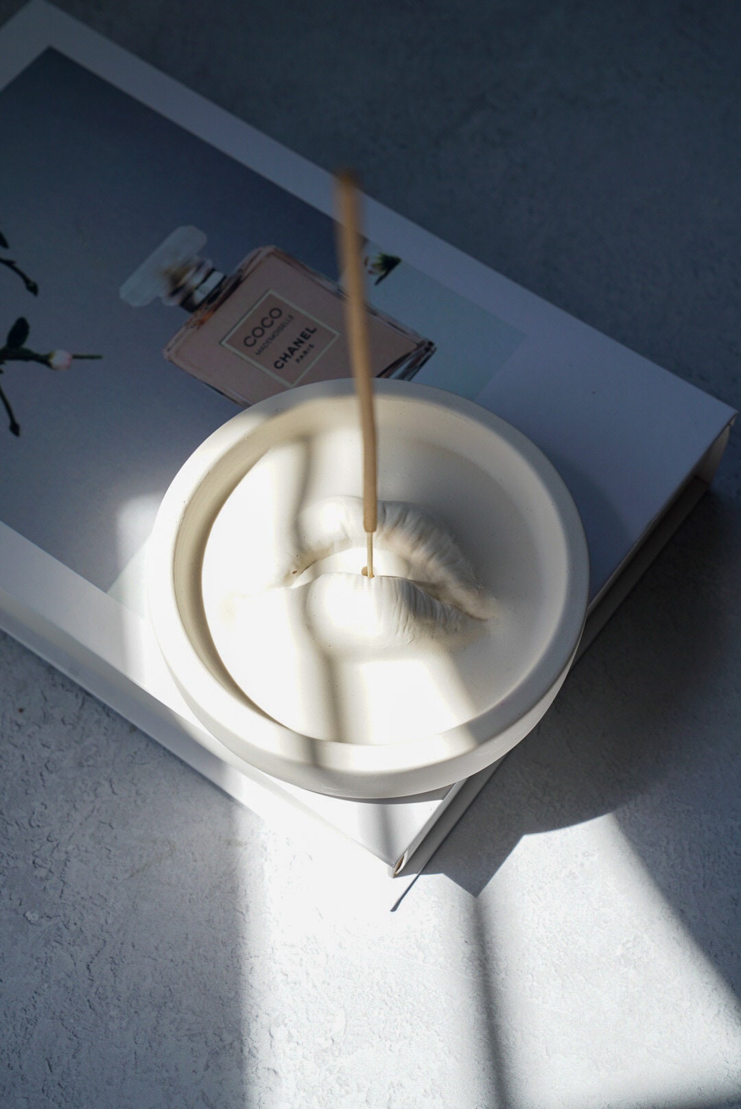Lip Incense Holder with incense stick on it.