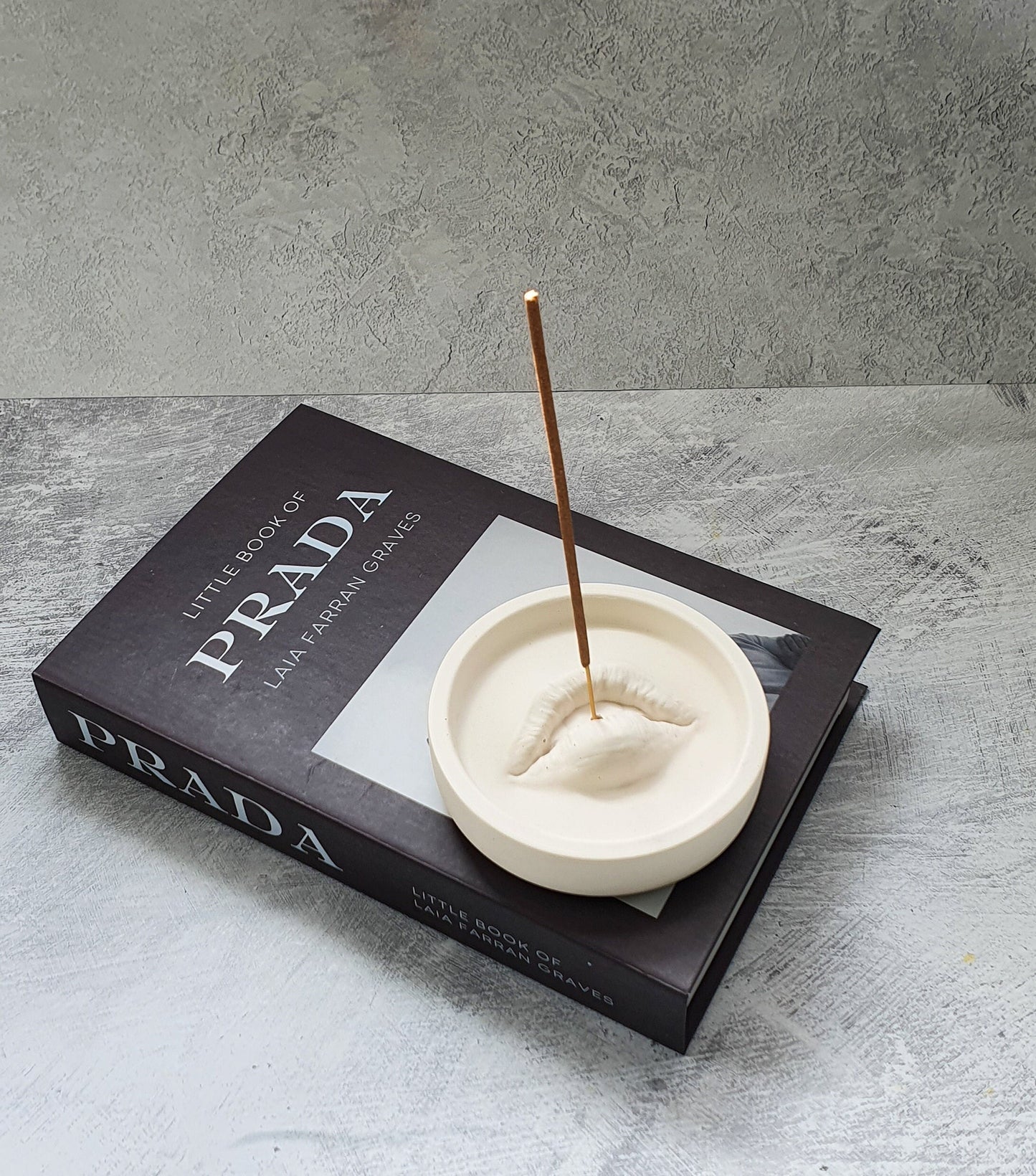 Lip Incense Holder with incense stick on it.