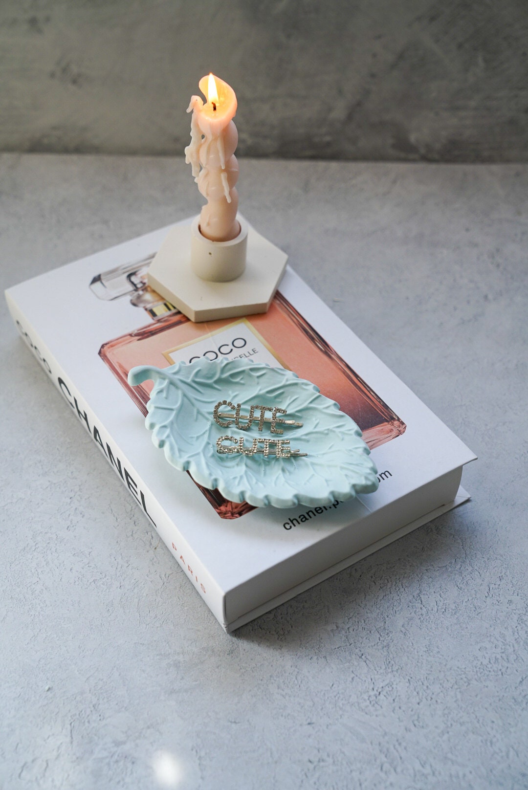 Leaf Trinket Dish on a magazine burning dinner candles next to it.