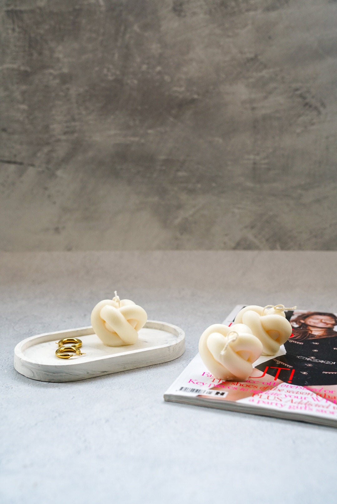 Knot Candles on a magazine.