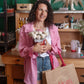 A lady holding Gokican's bag in the studio with flower bouquet candle in the studio