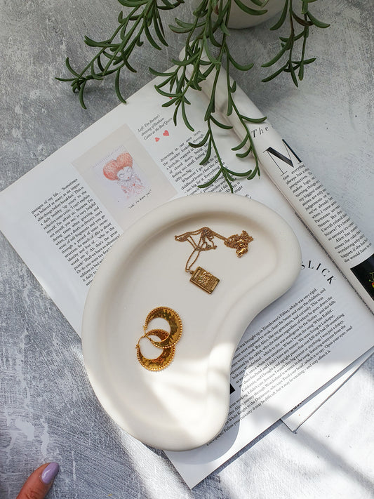 Large Irregular Jewellery Tray on a magazine. 