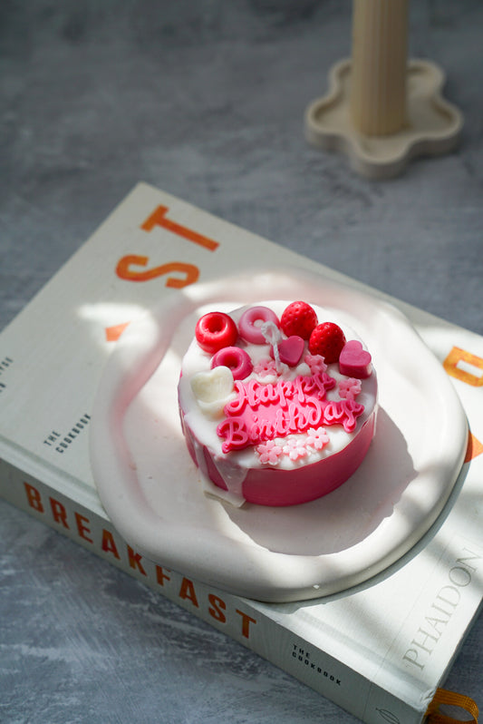 Custom Birthday Cake Candles written happy birthday on it.