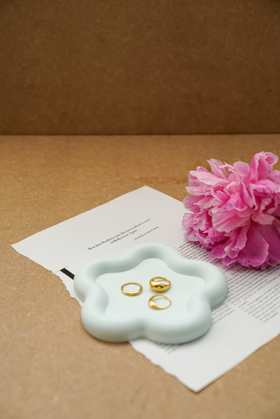 Flower Shaped Trinket Dish rings on it. 