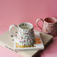 White Flower Ceramic Coffee Cup / Tea  Mugs sitting on magazine