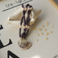 Necklace with shell pendant on a decorative background