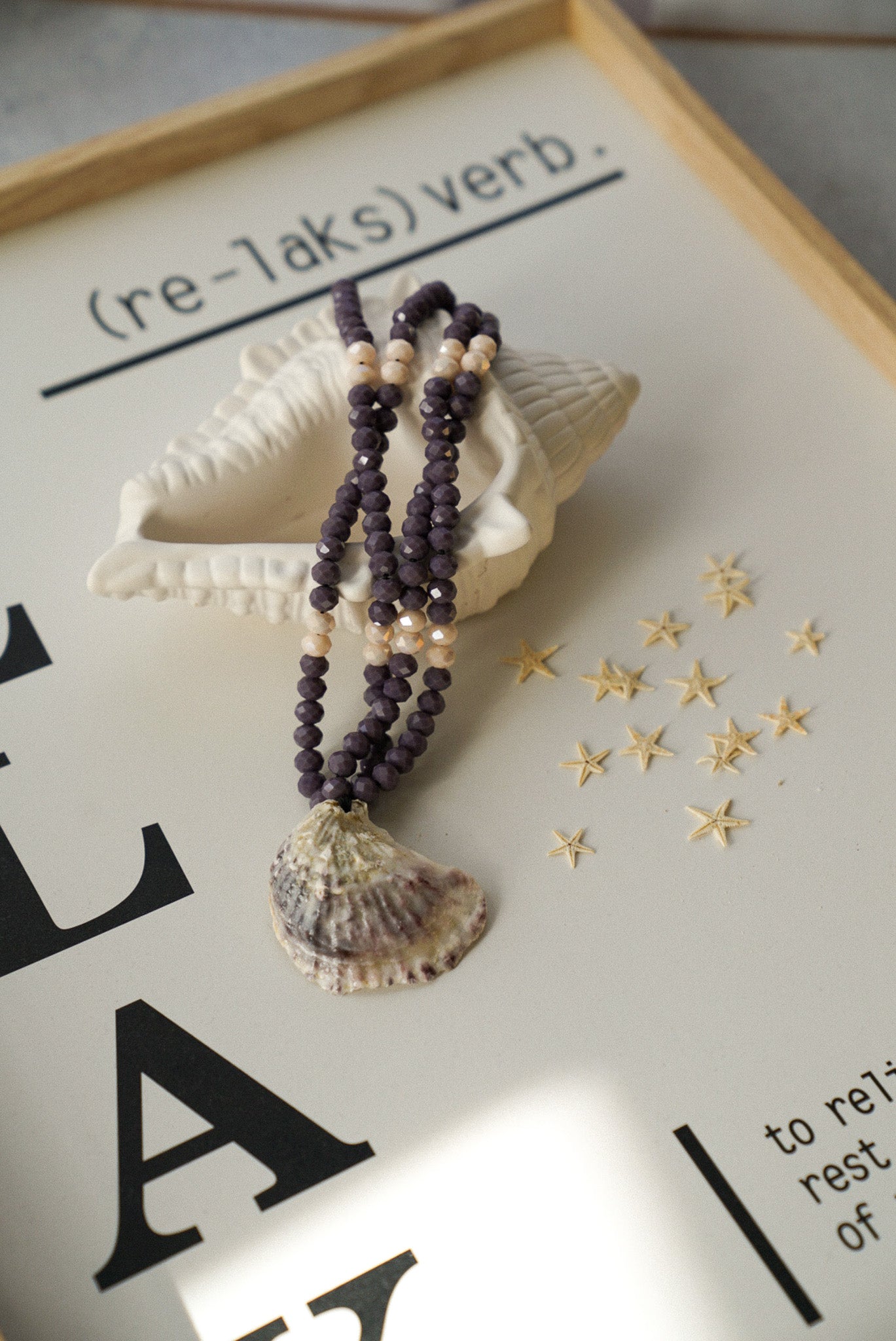Necklace with shell pendant on a decorative background
