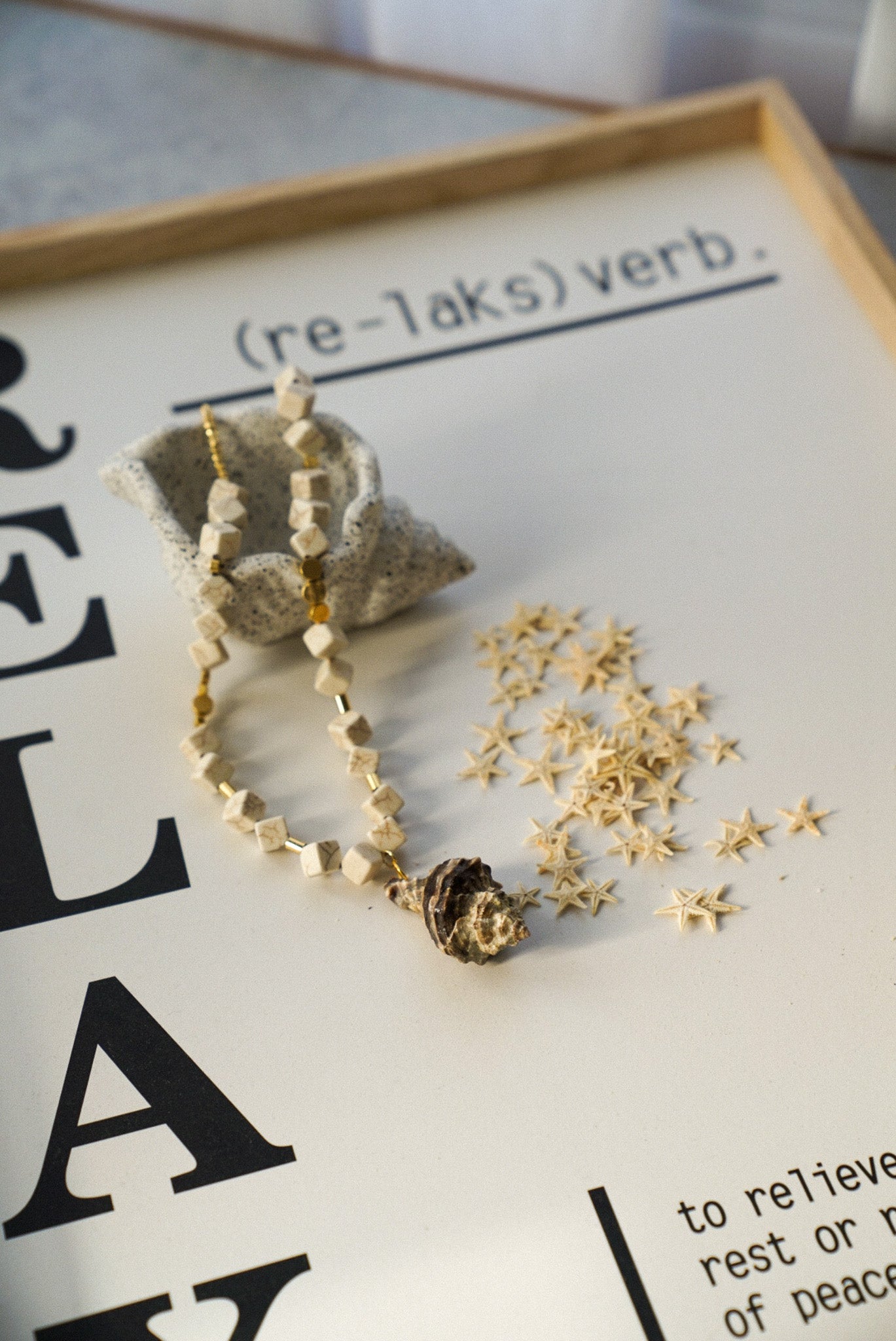 Necklace with shell shaped beads on a magazine page