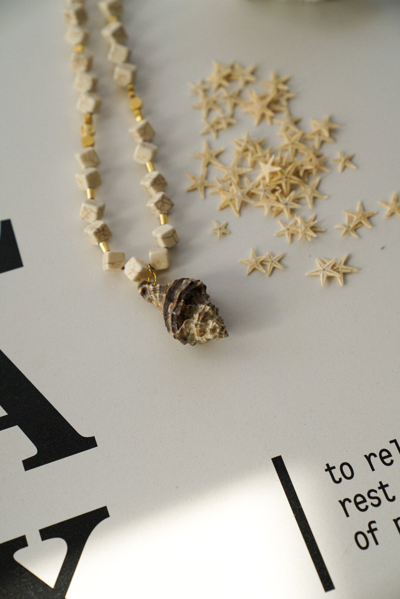 Cream Geometric Beaded Necklace With Natural Spiral Shell Pendant