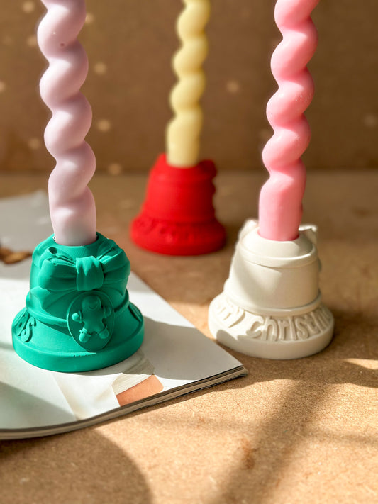 Green, white and red Christmas Candle Holders With Gingerbread twisted candle on it.