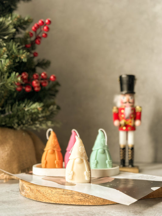 Ivory Gnome Scented Candles with nutcracker and Christmas tree on the back.