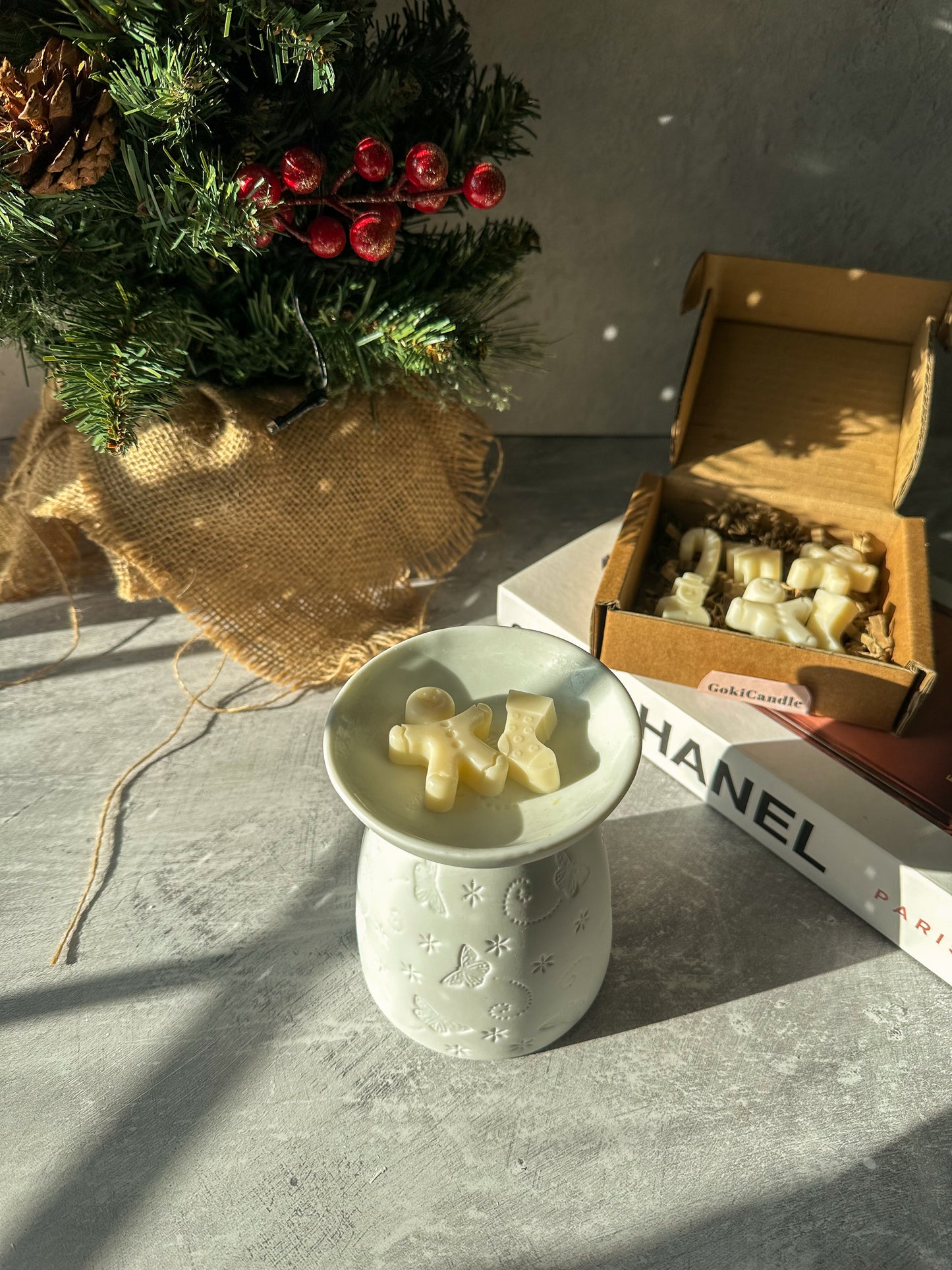 Christmas Spice Wax Melts with White Butterfly Wax MelterChristmas Spice Wax Melts with White Butterfly Wax Melter with Xmas tree on the background. 