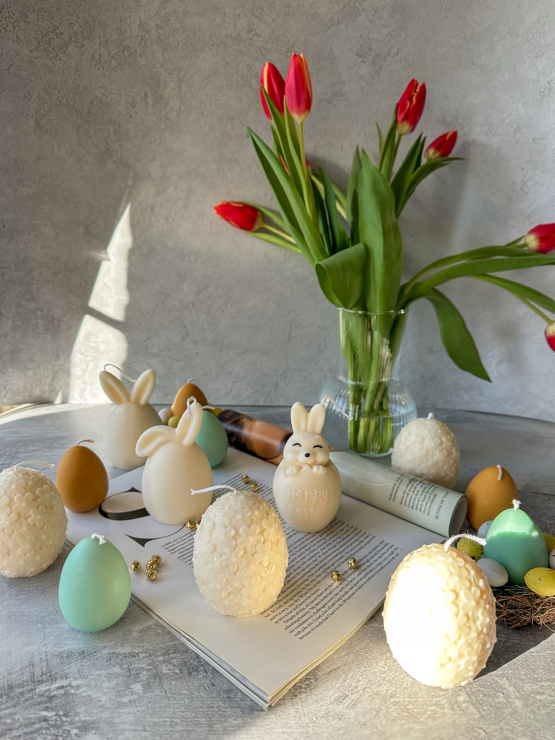 Easter Egg and easter bunny candles with flower on the background