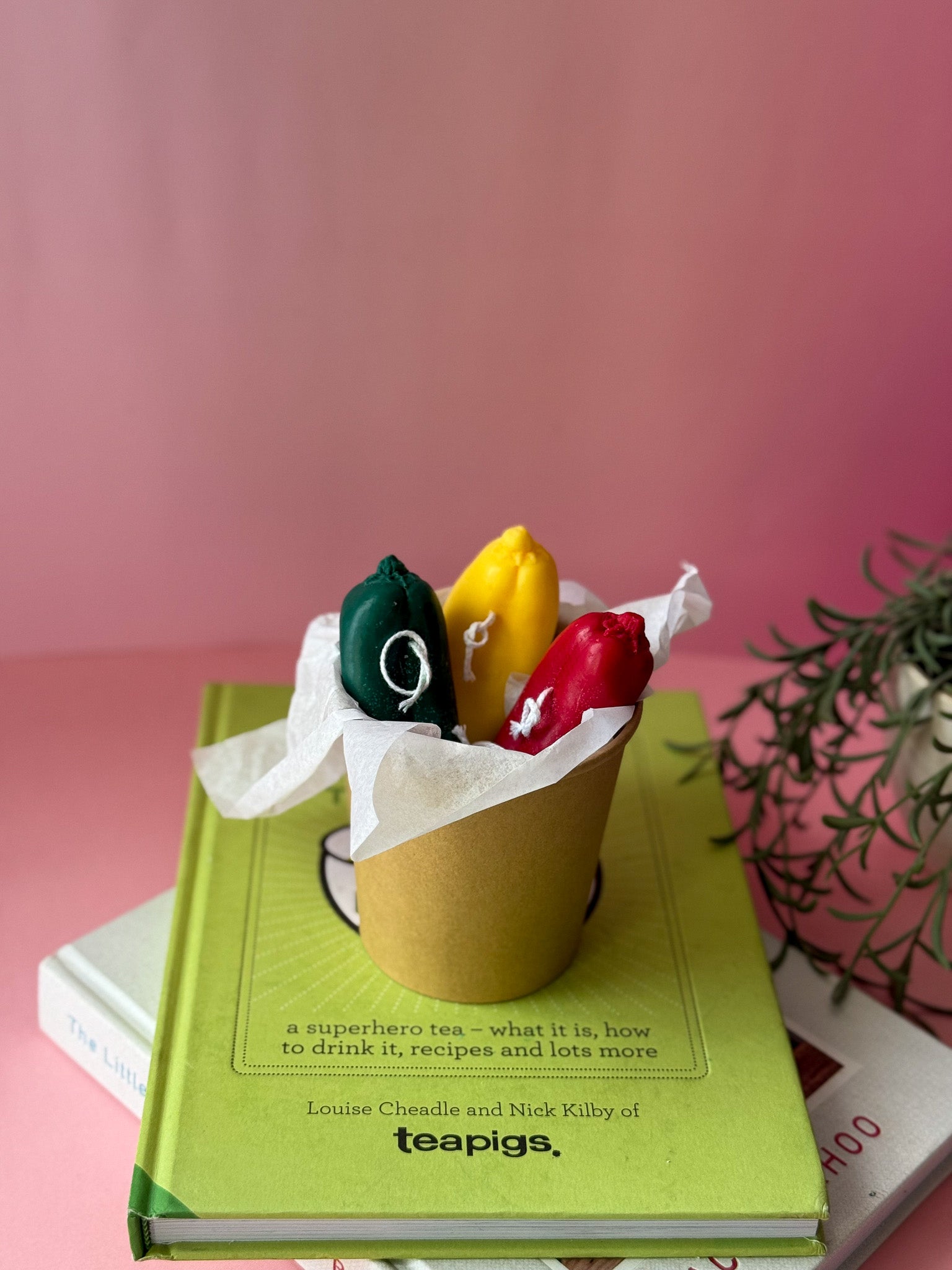 Chile Pepper Candles are red green and yellow sitting on a brown bowl
