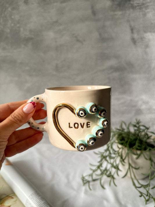 Holding a coffee mug on a grey background and plant on the back