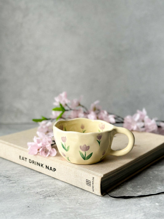 Tulip Ceramic Coffee Cup on magazine on a grey background.