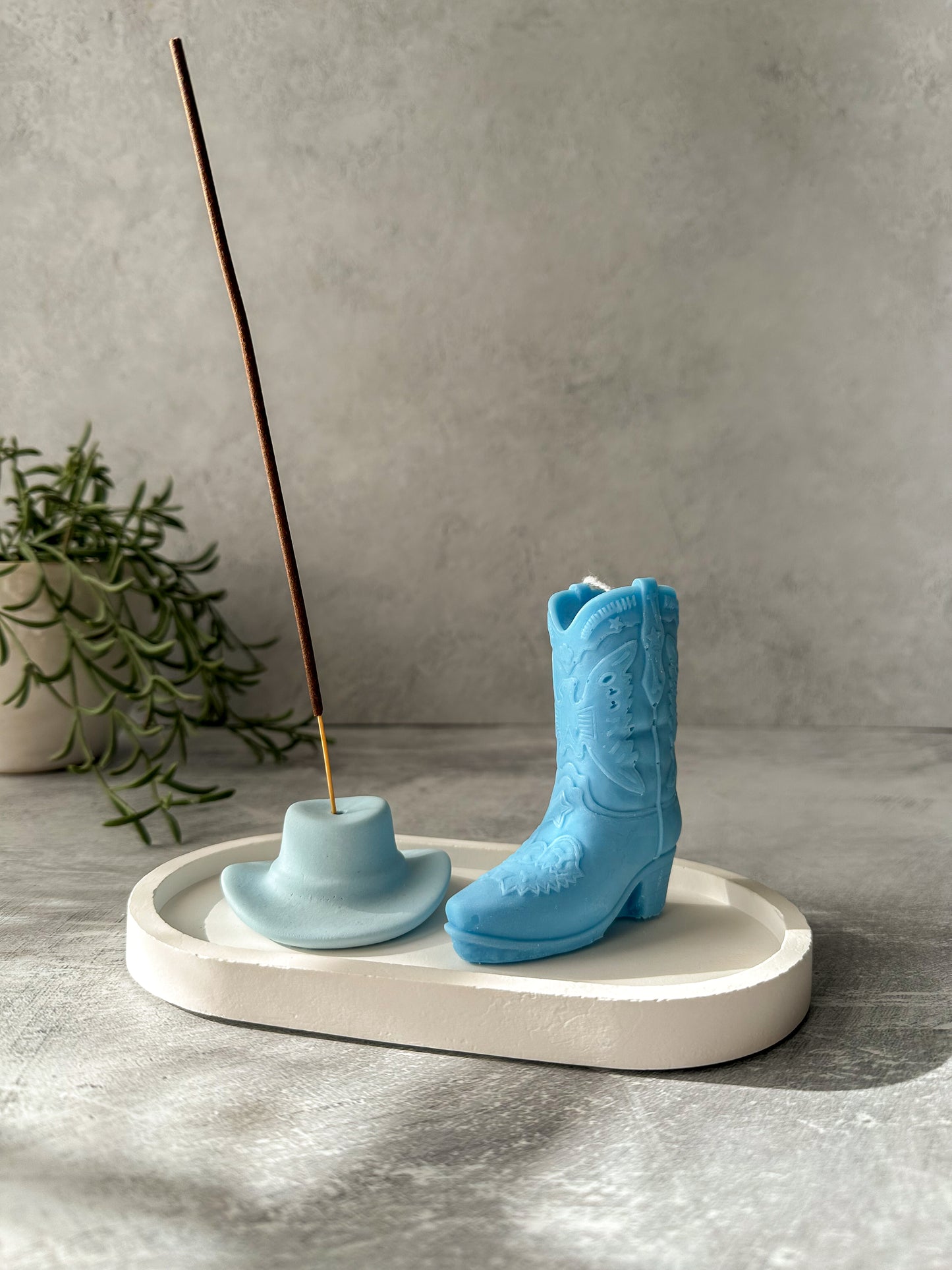 Baby blue  Cowboy Hat Incense Holder with incense in it sand blue cowboy boot sitting on a trinket dish.