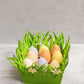 Easter Egg  Candles on a green fabric decor. 