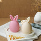 Pink and Ivory Easter Bunny Ear Up / Down Candles on a trinket tray.