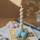 Flower Shaped Candle Holder with twisted burning candle on it.  