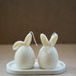 Ivory Easter Bunny Ear Up / Down Candles on a trinket dish. 