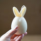 Holding Ivory Easter Bunny Ear Up Candle