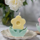 Yellow Flower Pillar Candle with rose background