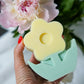 Holding Yellow Flower Pillar Candle with Peonies on the back