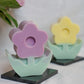 Lavender and Yellow Flower Pillar Candle with face vase on the background peonies in the vase