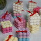Colourful bubble candles with a bow on 