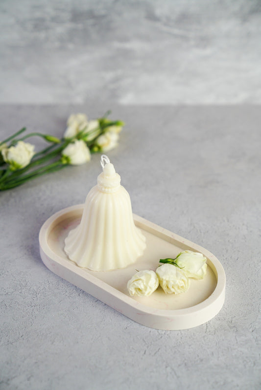 "Bell" shaped candle on a trinket dish with little roses next to it