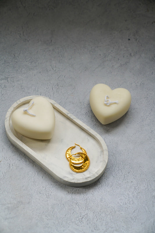 Heart-Shaped Candle on a trinket tray with earrings next to it and another Heart-Shaped Candle on the side. 