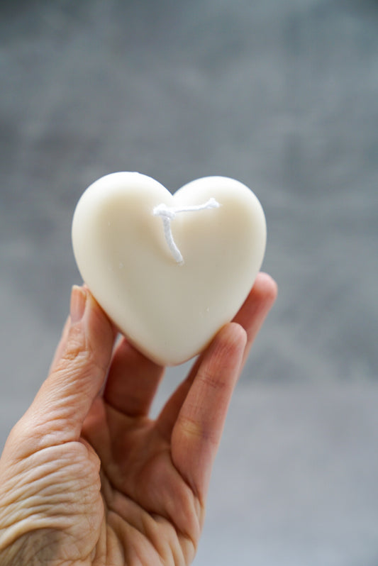 Holding Ivory Heart-Shaped Candle