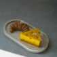 Cheese and croissant soy wax candle on a trinket dish