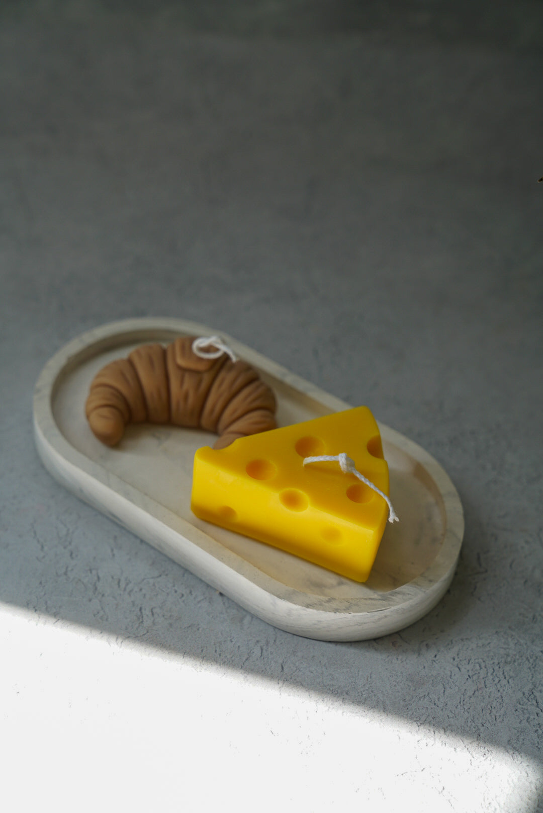 Cheese and croissant soy wax candle on a trinket dish