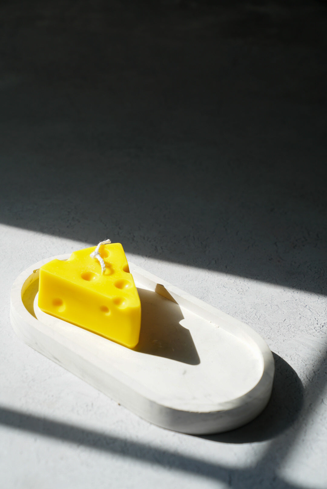 Cheese shape candle on a trinket dish