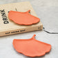 Terracotta Gingko leaf trinket tray on a magazine