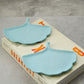 Baby Blue Gingko leaf trinket tray on magazine.