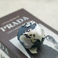 Black Globe Candle with silver painted on a magazine.