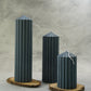 Grey Corinthian Pillar Candle Set on a wooden coaster