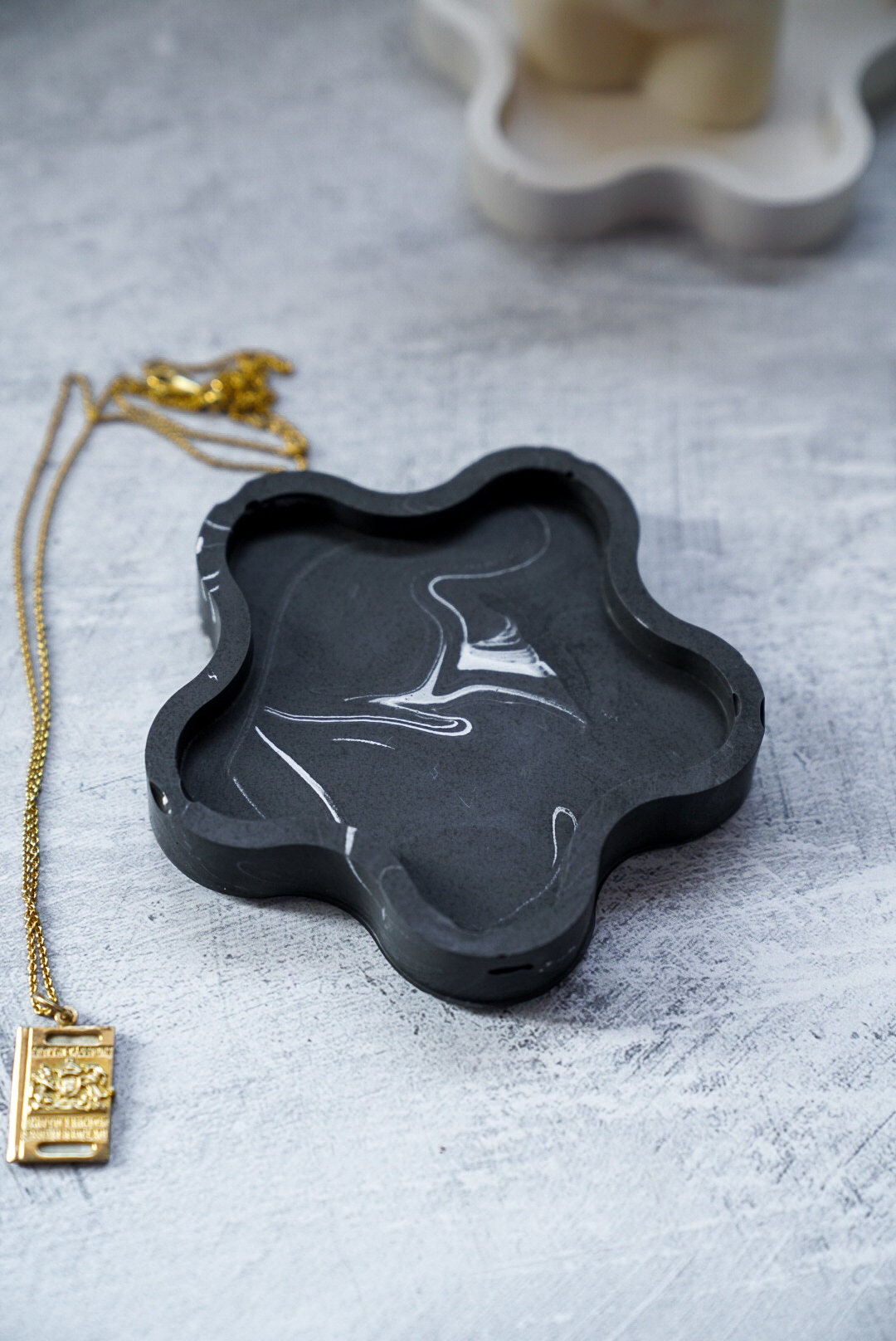 Black Blossom Trinket Dish with necklace next to it