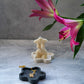 Black Blossom Trinket Dish with jewellery in it and female candle and flowers on the background 