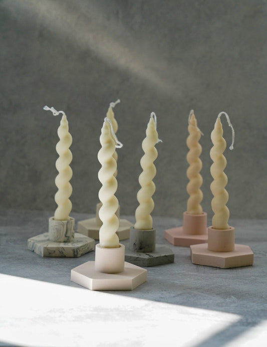 Geometric Candlestick holders with spiral candles on them.