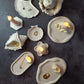 candles are sitting on a trinket trays. 