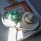Green an Ivory Knot Candle on a trinket tray. 